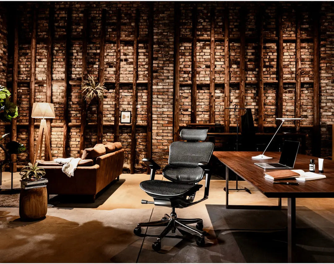 Ergohuman mesh chair in a warm brick-walled workspace